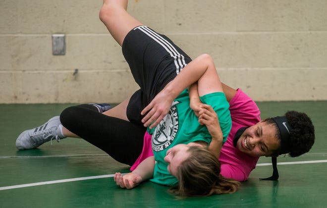 Richwoods freshman Lauryn Hudson, right, grapples with classmate Maggie Urich during wrestling practice Dec. 17, 2019 at Richwoods High School. The Knights 50-member wrestling roster includes 16 girls. [MATT DAYHOFF/JOURNAL STAR]