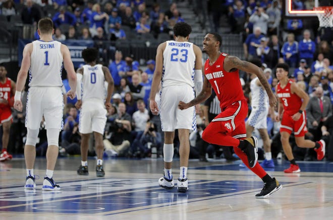 Ohio State's Luther Muhammad celebrates after the Buckeyes defeated Kentucky on Saturday in Las Vegas. It is one of the Buckeyes’ three wins against top-10 teams this season. [John Locher/The Associated Press]