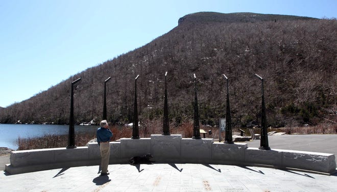 Dick Hamilton looks up where the profile of the Old Man of the Mountain used to be, Wednesday, April 24, 2013 in Franconia, N.H. [AP photo/Jim Cole, file]
