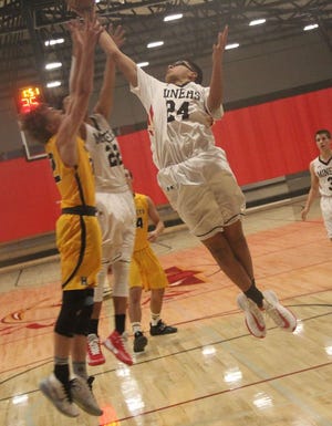 Randall Hughes grabs a rebound for the Yreka Miners versus Henley at home on Tuesday, Dec. 17. Photo by Bill Choy