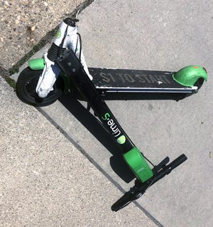 A broken Lime scooter on the sidewalk along S. Fourth St. in Downtown Columbus on May 8, 2019. [Fred Squillante/Dispatch]