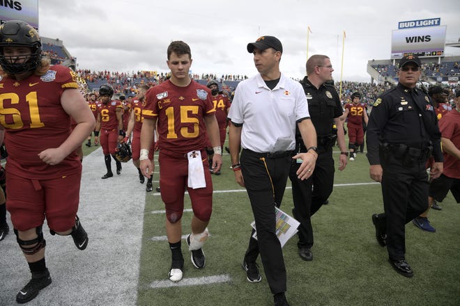 Iowa State quarterback Brock Purdy (15) leaves the field with head coach Matt Campbell, center, after the Camping World Bowl NCAA college football game against Notre Dame Saturday in Orlando. [Phelan M. Ebenhack/Associated Press]