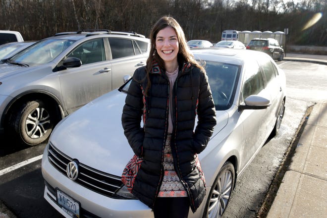 Hayley

Hutchins was the first customer at the new DMV in Cranston back in 2010. She's now a lawyer in the Rhode Island public defender's office. The car she was registering that day died; she is photographed with her present vehicle, a 2015 VW Jetta. [The Providence Journal / Kris Craig]