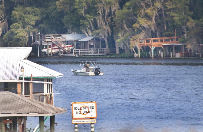 A law enforcement boat patrols the St. Johns River north of the Astor Bridge on Sept. 5 following Hurricane Dorian's passing through the area. [News-Journal file]