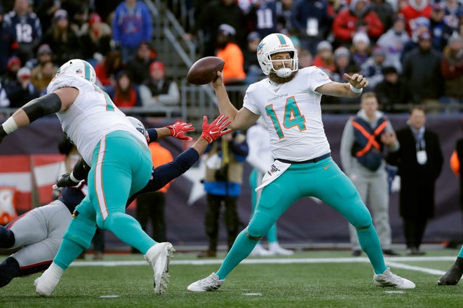 Miami Dolphins quarterback Ryan Fitzpatrick passes under pressure in the first half of an NFL football game against the New England Patriots, Sunday, Dec. 29, 2019, in Foxborough, Mass. (AP Photo/Elise Amendola)