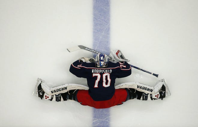 Blue Jackets goaltender Joonas Korpisalo, here stretching before a November game against Ottawa, will miss significant time after suffering a knee injury Sunday against Chicago. [Adam Cairns/Dispatch]