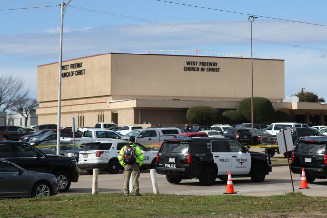 A person stands near the scene of a church shooting at West Freeway Church of Christ on Sunday, Dec. 29, 2019 in White Settlement, Texas. Jack Wilson, a reserve deputy with extensive training, was one of two congregants who confronted a gunman during an attack that killed two people at the church near Fort Worth. [Juan Figueroa/The Dallas Morning News via AP]