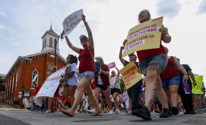 FILE - In this May 19, 2019 file photo, protesters for women's rights march past Dexter Avenue Baptist Church to the Alabama Capitol to protest a law passed making abortion a felony in nearly all cases with no exceptions for cases of rape or incest, in Montgomery. [AP Photo/Butch Dill, File]
