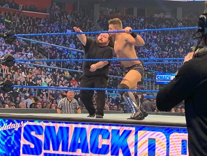 Local wrestler James Hamblin, left, is thrown out of the ring by WWE Superstar The Miz during a match on WWE SmackDown at Little Caesars Arena in Detroit. Hamblin played a henchmen of WWE Superstar Baron Corbin. A group of them entered the ring during the match between The Miz and Daniel Bryan.
