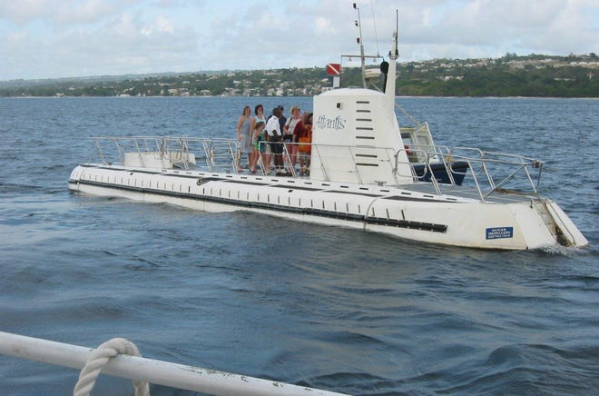 After alighting from another vessel a mile or so off Barbados, tourists board the 65-foot submarine Atlantis before it descends to a depth of nearly 150 feet. [Photo by Si Liberman]