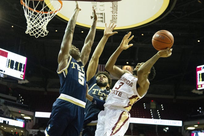 Florida State guard Trent Forrest attempts to shoot over Georgia Tech forward Moses Wright (5) and forward James Banks III in the second half Tuesday in Tallahassee. Florida State defeated Georgia Tech 70-58. [Mark Wallheiser/The Associated Press]