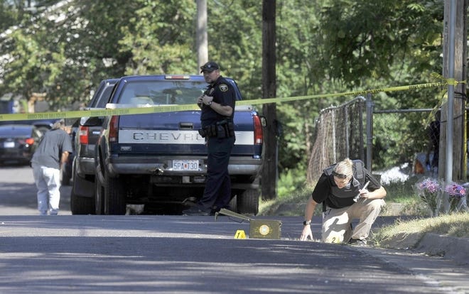 Columbia crime scene investigator Erin Hull looks for evidence Sept. 26 at the scene of the shooting death of James D. Hickem, 23, near McBaine Avenue and Duncan Street. Hickem's death was the sixth from gun violence in a two-week period of September. [Don Shrubshell/Tribune]