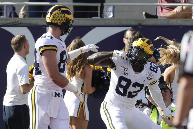 Michigan tight end Nick Eubanks (82) celebrates his touchdown reception against Alabama with tight end Sean McKeon during the first half of the Citrus Bowl NCAA college football game, Wednesday, Jan. 1, 2020, in Orlando, Fla. (AP Photo/John Raoux)