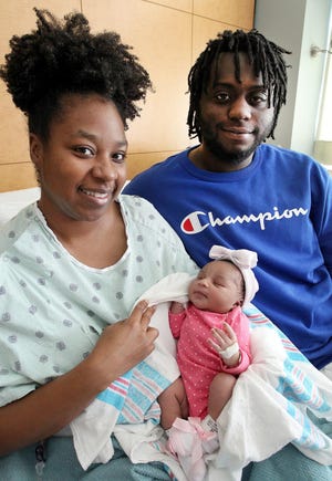 Shakira Love, left, and Devonte Hughes with their daughter, Lennox McKenzie Hughes, who was the first baby born in Gaston County this year. [JOHN CLARK/THE GASTON GAZETTE]