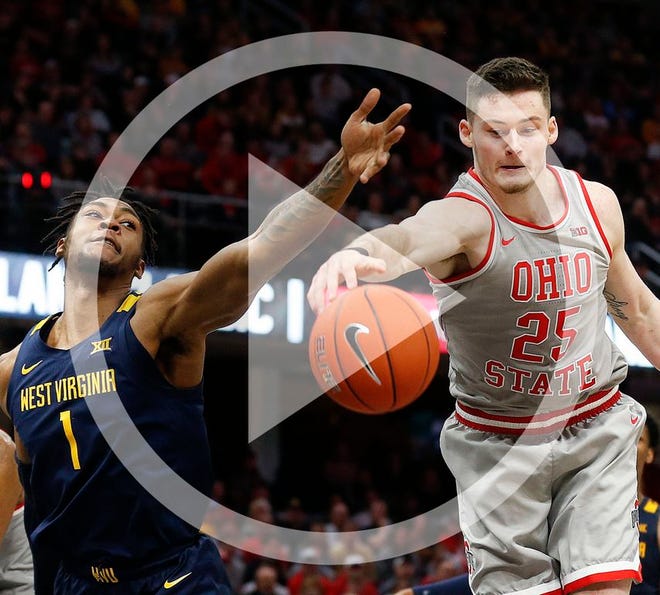 In this file photo Ohio State's Kyle Young (25) grabs a rebound against West Virginia's Derek Culver (1) during the second half of an NCAA college basketball game Sunday, Dec. 29, 2019, in Cleveland.