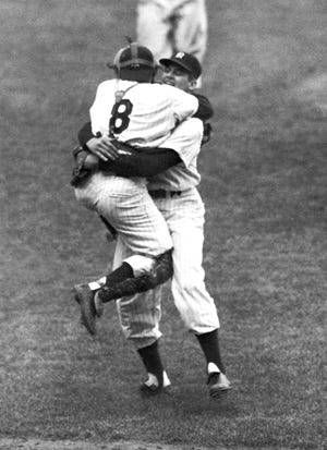 In this Oct. 8, 1956, file photo, New York Yankees catcher Yogi Berra leaps into the arms of pitcher Don Larsen after Larsen struck out the last Brooklyn Dodgers batter to complete his perfect game during Game 5 of the World Series in New York. Larsen, the journeyman pitcher who reached the heights of baseball glory in 1956 for the Yankees when he threw a perfect game and only no-hitter in World Series history, died Wednesday. He was 90. [Associated Press File Photo]