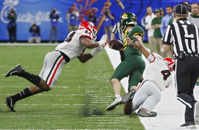 Georgia Bulldogs defensive lineman Travon Walker (44) and Georgia Bulldogs linebacker Nolan Smith (4) take down Baylor Bears quarterback Charlie Brewer (12) on a keeper. Walker was flagged for a late hit and Brewer did not return to the game during the Sugar Bowl football game between the Georgia Bulldogs and the Baylor Bears at the Superdome in New Orleans on Jan. 1, 2020. Georgia won 26 to 14. (Bob Andres bandres/Atlanta Journal-Constitution via AP)