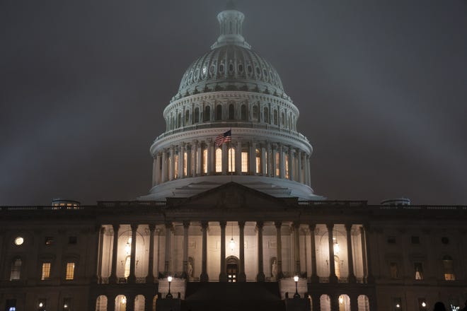 The U.S. Capitol in Washington is shrouded in mist, Friday night, Dec. 13, 2019, at the end of an acrimonious week of partisan disputes in the House Judiciary Committee which approved two articles of impeachment against President Donald Trump, Friday, Dec. 13, 2019. The full House of Representatives, controlled by the Democrats, is expected to vote on the charges of abuse of power and obstruction of Congress before lawmakers depart for the holidays. (AP Photo/J. Scott Applewhite)
