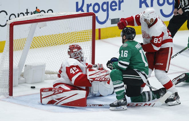 Dallas Stars forward Joe Pavelski (16) and Detroit Red Wings defenseman Trevor Daley (83) look on as the puck slips past goaltender Jonathan Bernier (45) during the third period of an NHL hockey game Friday, Jan. 3, 2020, in Dallas. Upon video review the goal was disallowed due to goaltender interference. (AP Photo/Brandon Wade)
