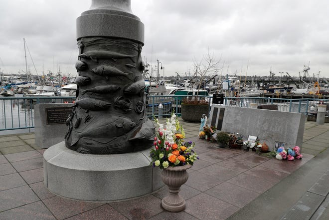The Seattle Fishermen's Memorial is shown Thursday, Jan. 2, 2020 in Seattle. Items left at the memorial Thursday included a ball cap with the name of the crab fishing boat Scandies Rose. The search for five crew members of the Scandies Rose in Alaska has been suspended, the U.S. Coast Guard said after two other crew members of the vessel were rescued after the 130-foot crab fishing boat from Dutch Harbor, Alaska, sank on New Year's Eve. (AP Photo/Ted S. Warren)