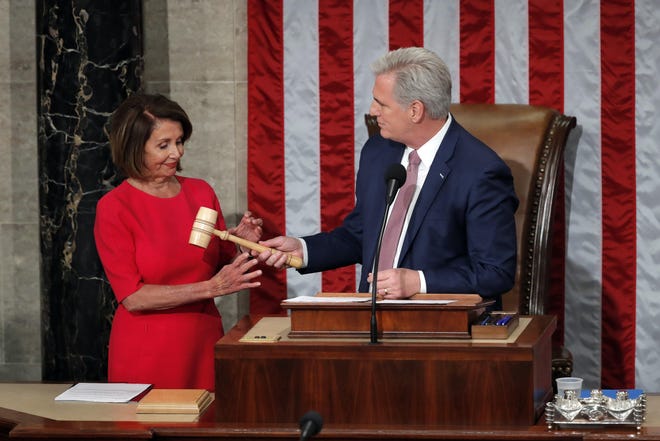 House speaker Nancy Pelosi of California, who will lead the 116th Congress as Speaker of the House is handed the gavel by Rep. Kevin McCarthy, R-Calif., at the U.S. Capitol in Washington, on Jan. 3, 2019. [Carolyn Kaster/The Associated Press]
