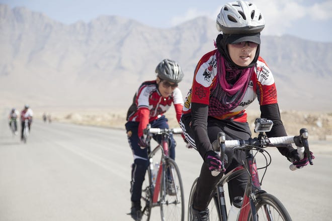 Zahra leads the pack on a 2014 training ride with the Women's National Cycling Team of Afghanistan. [Photo/Jenny Nichols]