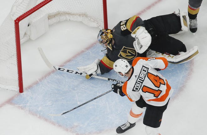 Flyers center Sean Couturier scores on Golden Knights goaltender Marc-Andre Fleury during Thursday night’s game. [JOHN LOCHER / ASSOCIATED PRESS FILE]