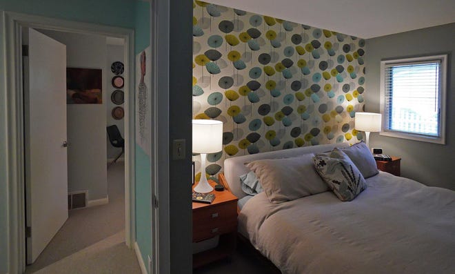 The master bedroom in interior designer Cy Winship’s suburban rambler has a wallpapered accent wall, "Dandelion Clocks." [BRIAN PETERSON/MINNEAPOLIS STAR TRIBUNE/TNS]