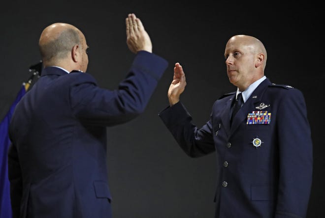 Air Force Col. Jeremy Reeves, right, recites the oath of office with Retired Air Force Col. David Lewis, left, during a ceremony Friday, Jan. 3, 2020, at Escondido Theatre in Lubbock, Texas. [Brad Tollefson/A-J Media]