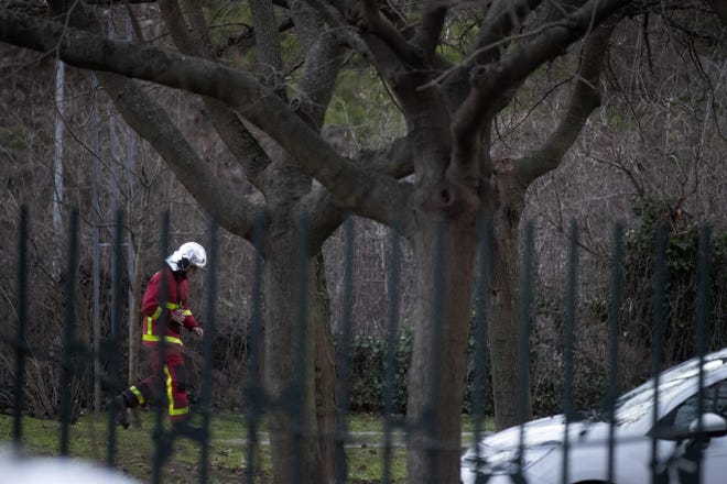 A rescue worker walks in a park after a man attacked passerby Friday in Villejuif, south of Paris. A man armed with a knife rampaged through a Paris park attacking passers-by seemingly at random Friday, killing at least one person and injuring two others before police shot him dead, officials said. [Michel Euler/The Associated Press]