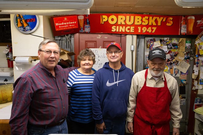 From left, Bill Pierson, Cecelia Pierson, Matthew Porubsky and Charlie Porubsky work at Porubsky's, a grocery store and deli known for its chili and hot pickles. [Evert Nelson/The Capital-Journal]