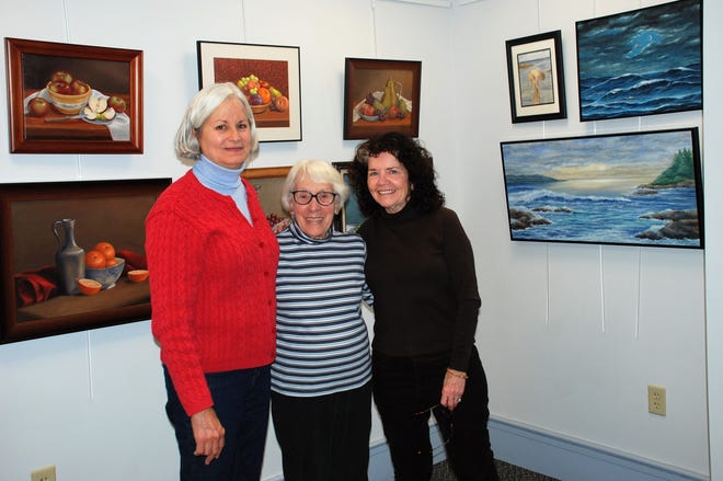Leeann Lamsa, Mary J. Dunn and Mary Waight set up the first-ever Little Art Gallery at Town Hall in Westminster on Jan. 2. Dunn's art will be available for all to see during Town Hall's regular hours every week until the end of January. The gallery was created to showcase local art talent. [News staff photo by Doneen Durling]