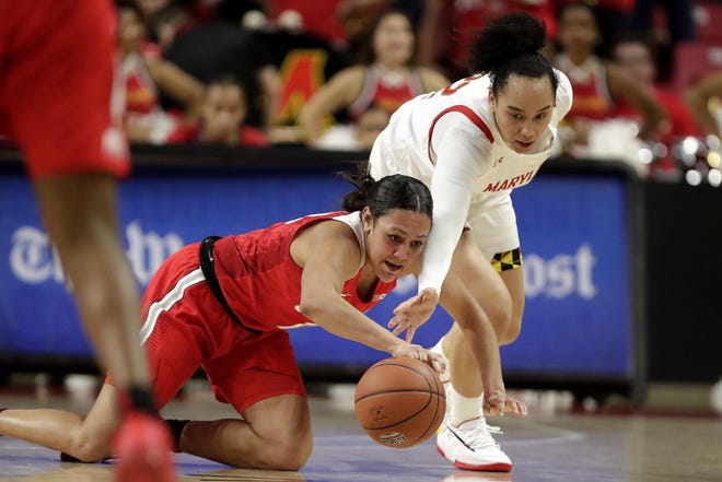 Ohio State guard Braxtin Miller, left, and Maryland guard Blair Watson compete for the ball during the second half of the game Monday, Jan. 6, 2020, in College Park, Md. [Julio Cortez/The Associated Press]