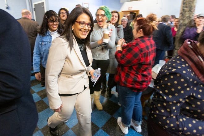 Topeka Mayor Michelle De La Isla makes her way through a crowd of supporters in the back of Juli's Coffee and Bistro Monday Morning to announce her campaign for 2nd District U.S. House seat currently occupied by Steve Watkins. [Evert Nelson/The Capital-Journal]