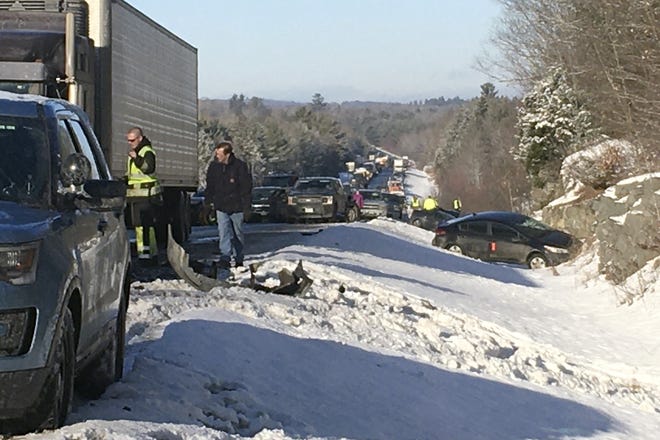 Emergency personnel work at the scene of a multi-car accident on Interstate 95, Tuesday, Jan. 7, 2020, in Carmel, Maine [Linda Coan O'Kresik/The Bangor Daily News via AP]