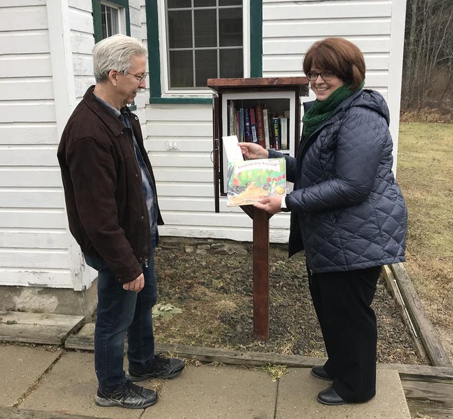 Jennifer Cushing, president of the Hornby Historical Society, and Mark Gilbert, Shady Grove Church Reverend, each feel the addition of a Little Free Library at the Shady Grove Schoolhouse is a great asset to the community. [Jeff Smith/The Leader]