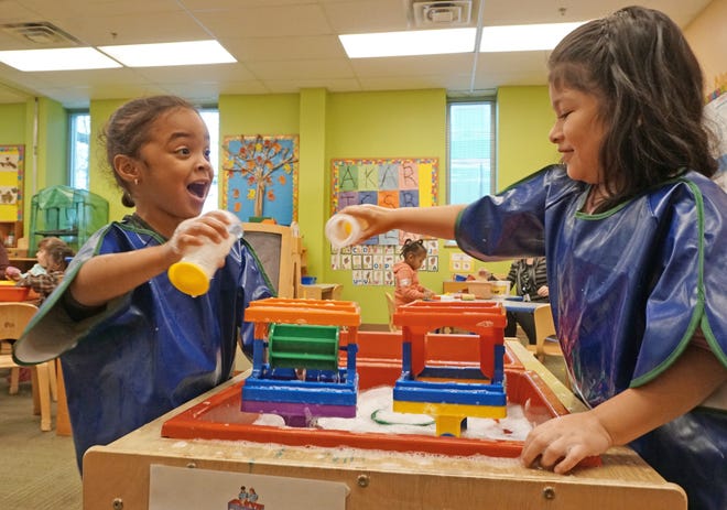 Jeslynne Ramirez and Allison Nejia Itzep enjoy playing at the water table as the Dorcas International Institute opened its newly renovated Mariposa Wing and celebrated the launch of a Head Start preschool program in that Providence space on Tuesday. [The Providence Journal / Sandor Bodo]