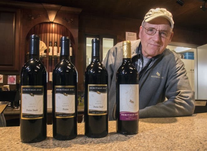 Heritage Oaks Winery owner Tom Hoffman stands with some of his wines at the winery in Acampo. The Lodi Association of Wineries will hold the first Celebrate Petite Sirah weekend Jan. 18-19 in Lodi, whose hospitable Mediterranean climate and various soil types are ideal for the more than 100 varieties from around the world that thrive in the region. [CLIFFORD OTO/THE RECORD]