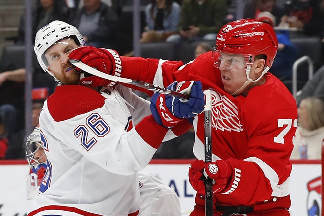 Detroit Red Wings left wing Adam Erne (73) hits Montreal Canadiens defenseman Jeff Petry (26) while battling for position in the second period of an NHL hockey game Tuesday, Jan. 7, 2020, in Detroit. (AP Photo/Paul Sancya)