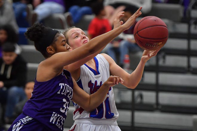 Seaman junior Raigan Kramer, right, drives for a shot against Topeka West's Adina Davis on Tuesday night. Kramer had 15 points, including a pair of 3-pointers, in the Vikings' 63-33 win. [Rex Wolf/Special to The Capital-Journal]