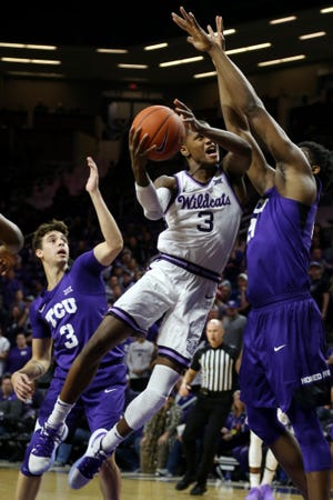 Kansas State guard DaJuan Gordon (3) drives the basket against TCU's Francisco Farabello (3) and Kevin Samuel (21) during the first half Tuesday night at Bramlage Coliseum. [SCOTT SEWELL/USA TODAY SPORTS]