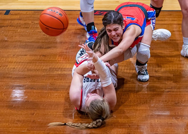 Lake Travis Cavaliers forward Jackie Cilliers passes off the ball after stealing the ball from Hays Rebels guard Madison Logan during the fourth period of a District 25-6A girls basketball game on Jan. 7 at Lake Travis High School. [JOHN GUTIERREZ/FOR STATESMAN]