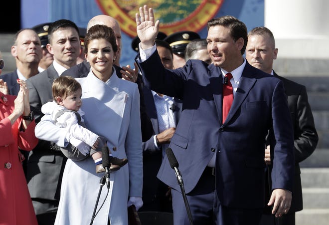 Gov. Ron DeSantis, right, waves during an inauguration ceremony with his wife Casey and son Mason, on Jan. 8, 2019, in Tallahassee. [Lynne Sladky/The Associated Press]
