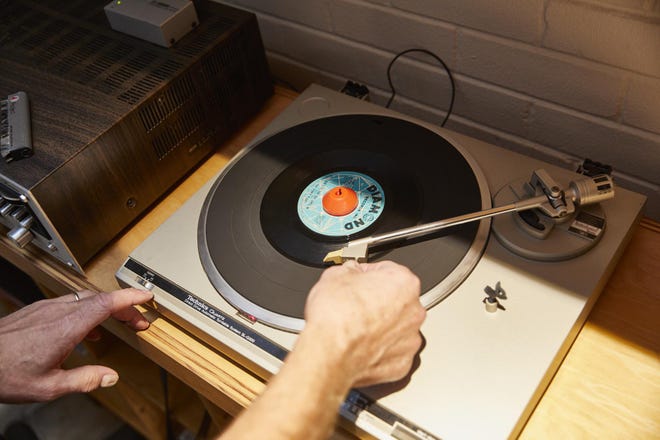 What do you want to hear? The playlist is up to the guests at KOOP Radio’s vinyl night. [DAVE CREANEY FOR STATESMAN]