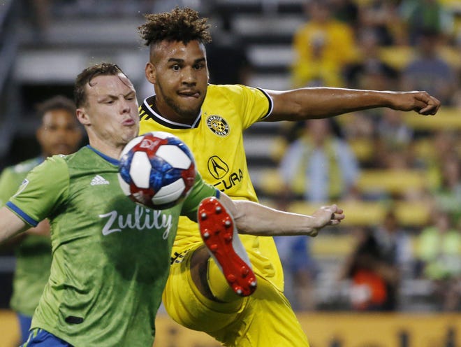 Crew forward JJ Williams kicks the ball in front of Seattle Sounders defender Brad Smith during the first half of a game July 6, 2019, at Mapfre Stadium. [Fred Squillante/Dispatch]
