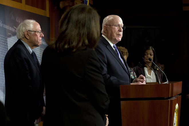 Sen. Patrick Leahy, D-Vt. accompanied by Sen. Bernie Sanders, I-Vt., Rep. Pramila Jayapal, D-Wash., and other members, speaks during a news conference on a measure limiting President Donald Trump's ability to take military action against Iran, on Capitol Hill, in Washington, Thursday. [JOSE LUIS MAGANA/ASSOCIATED PRESS]