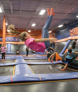 Chelsea Newhouser flips in midair at Sky Zone indoor trampoline park. (CantonRep.com / Aaron Self)