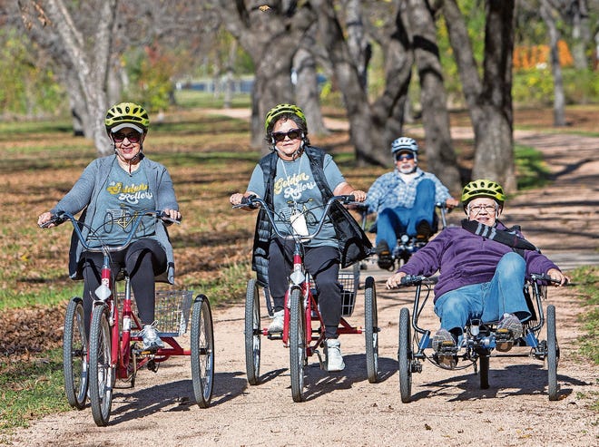 Mary Lyons (left), Yolanda Esparza (center) and Antonia Sandoval (right) complete a group trail ride originating from the Conley-Guerrero Senior Activity Center in Austin, Texas. [Julia Robinson for KHN]