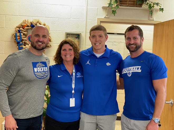 New Deltona football coach Jeff Smothers (third from left) poses with Principal Intern Mike Micallef, Principal Carolyn Carbonell and athletic director Cory Flickinger. [PHOTO PROVIDED BY CORY FLICKINGER]