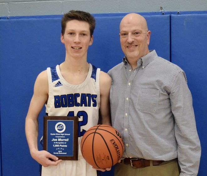 Oyster River High School senior Joe Morrell, left, with coach Lorne Lucas after Friday's milestone night. [Ryan O'Leary/Seacoastonline]